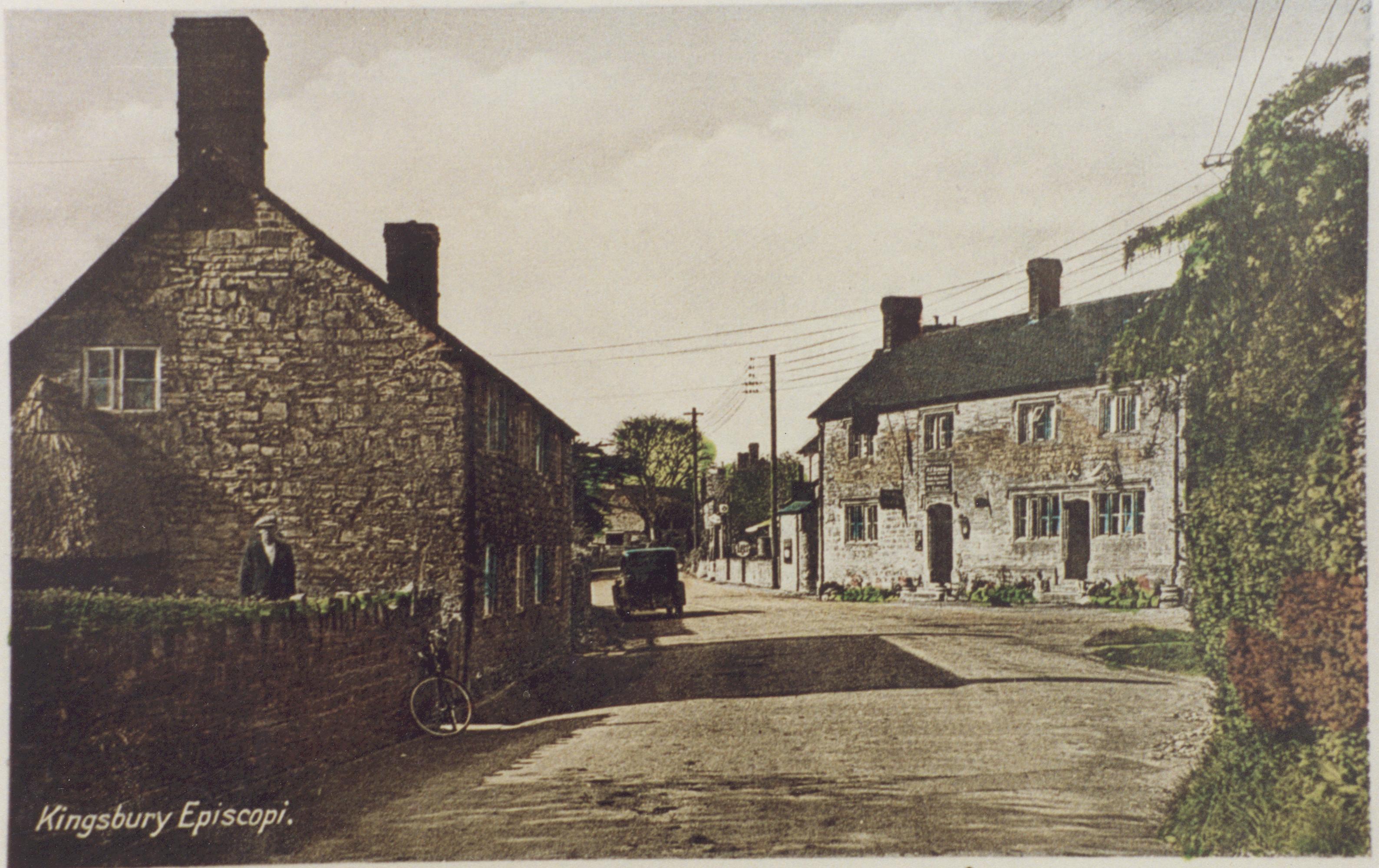 Colour postcard looking west past Wyndham Arms, Gummers Cottage on left.