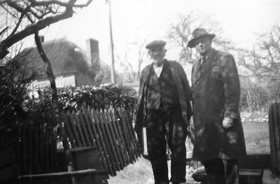 Two men in lane with snow on ground