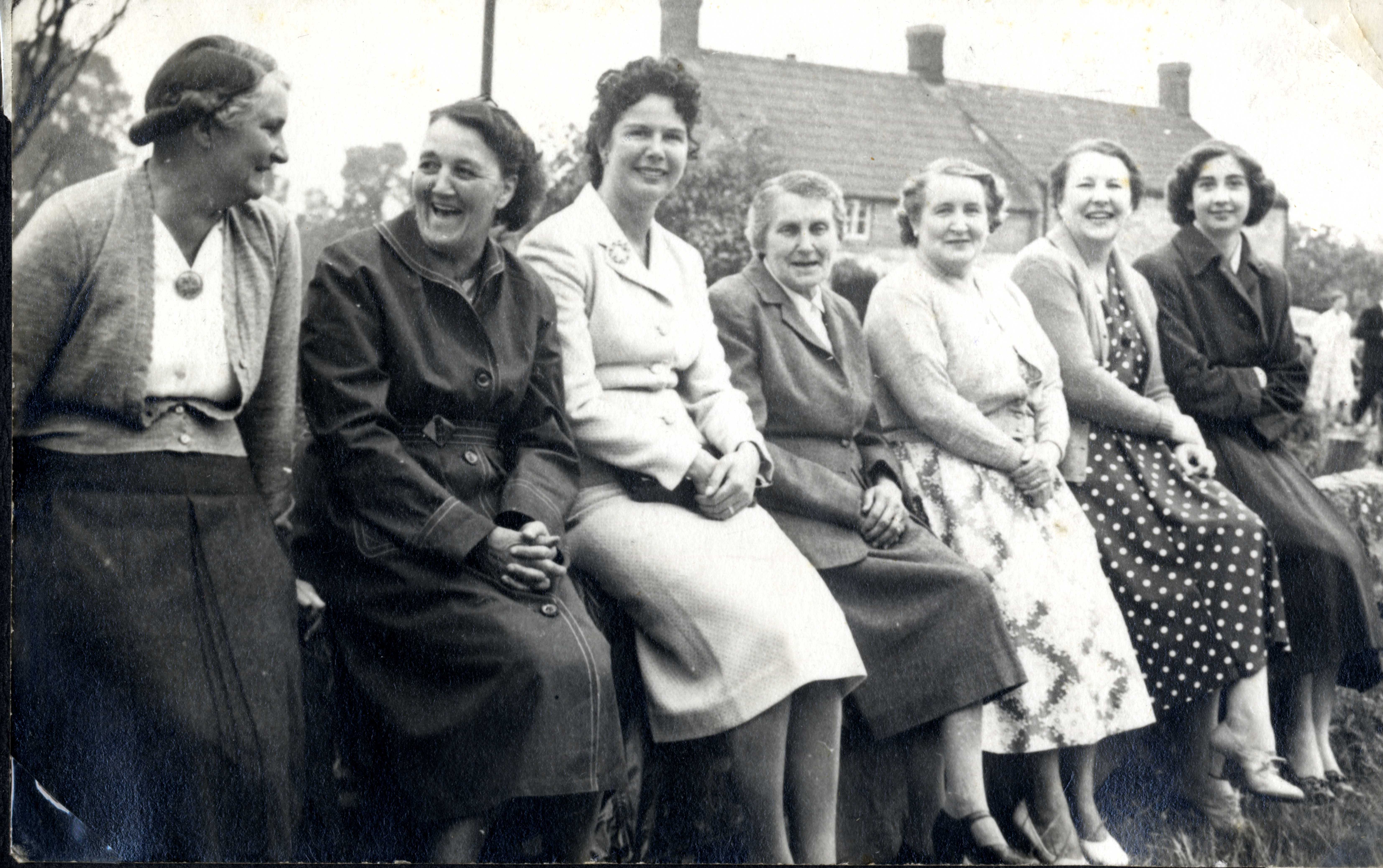 Women sitting on a wall