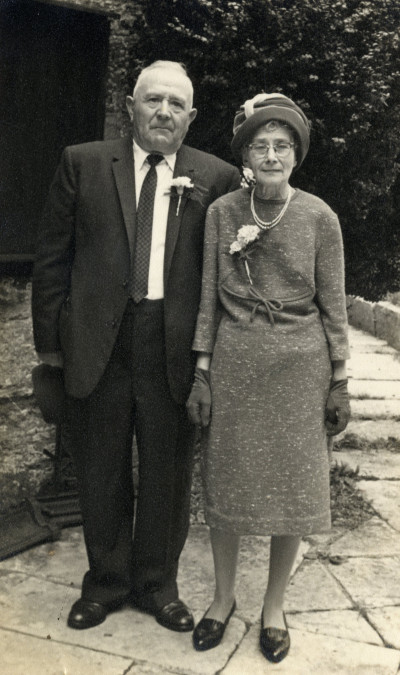 Elderly couple  wearing buttonholes.