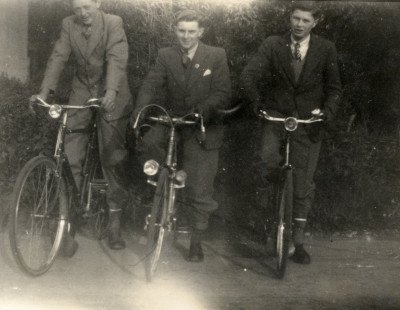 Three men on bikes.