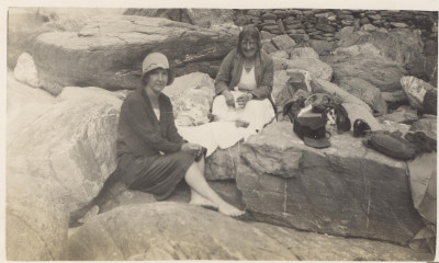 Two women on rocky beach