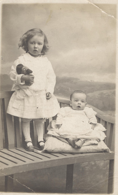 Child & baby in studio photo.