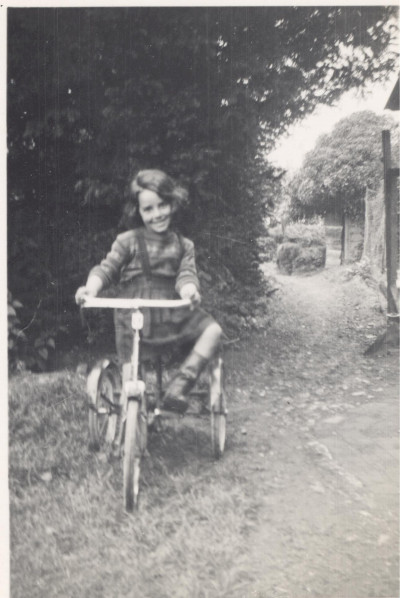 Girl on tricycle.