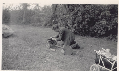 Man mending grass mower