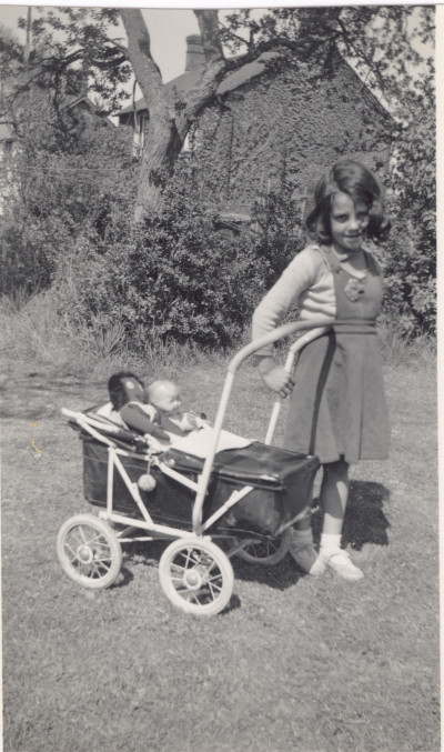 Unknown girl with dolls pram.