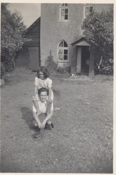 Woman and child outside house.