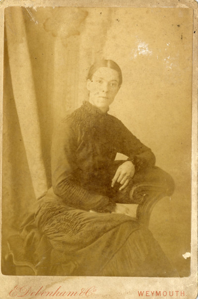 Woman in Victorian dress, seated