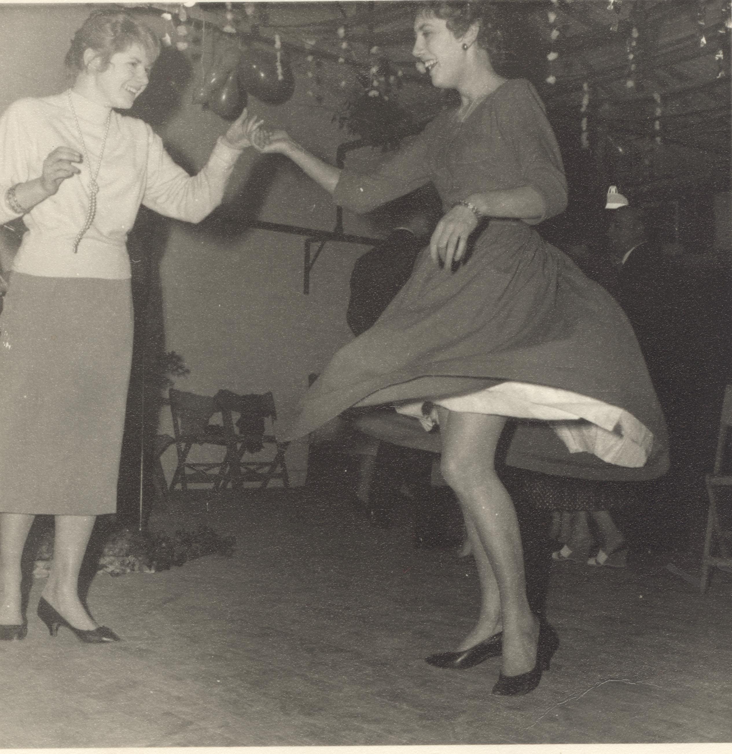 Two women dancing.