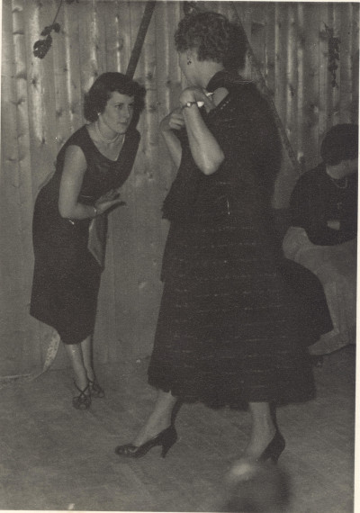 Two women dancing at glovers party.