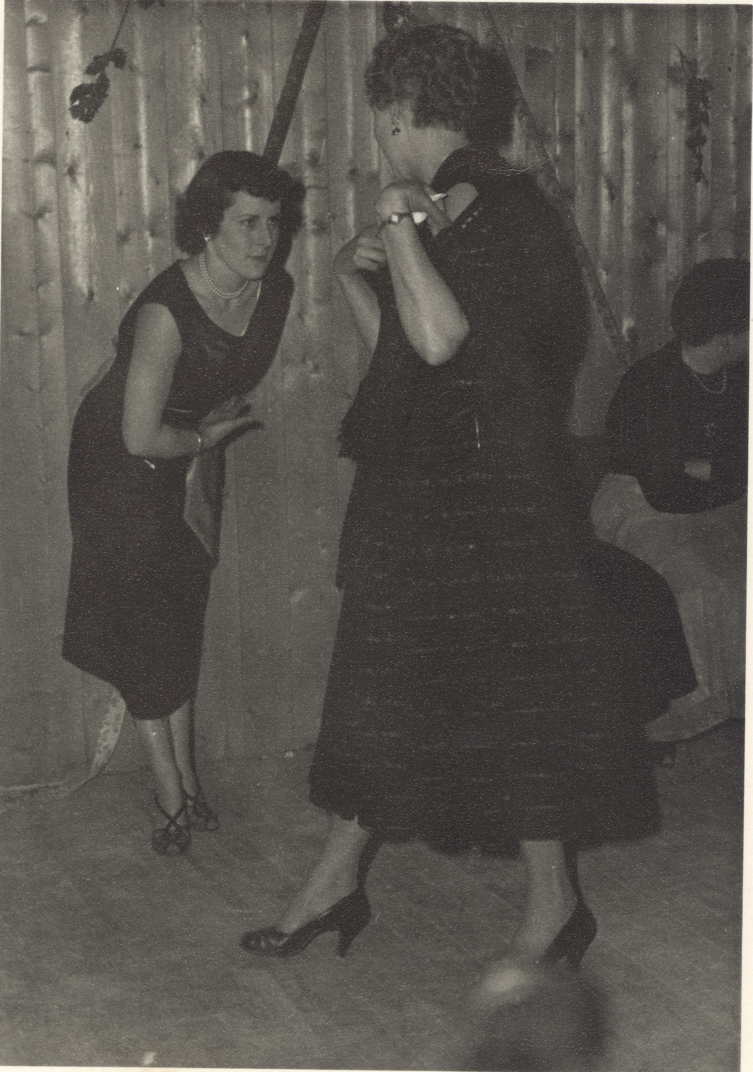Two women dancing at glovers party.