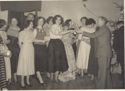Large group of women at gloving social event.