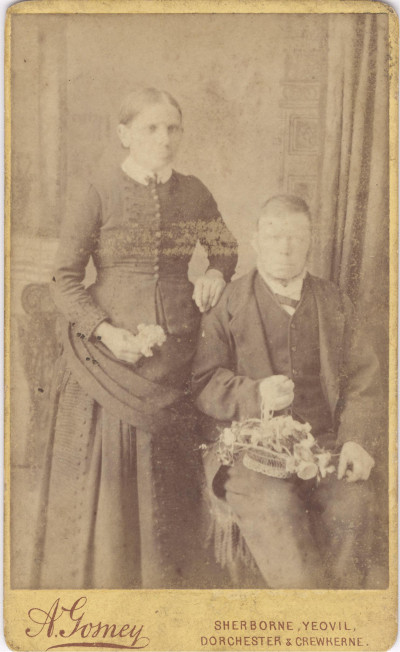 Victorian man and woman in studio photo.