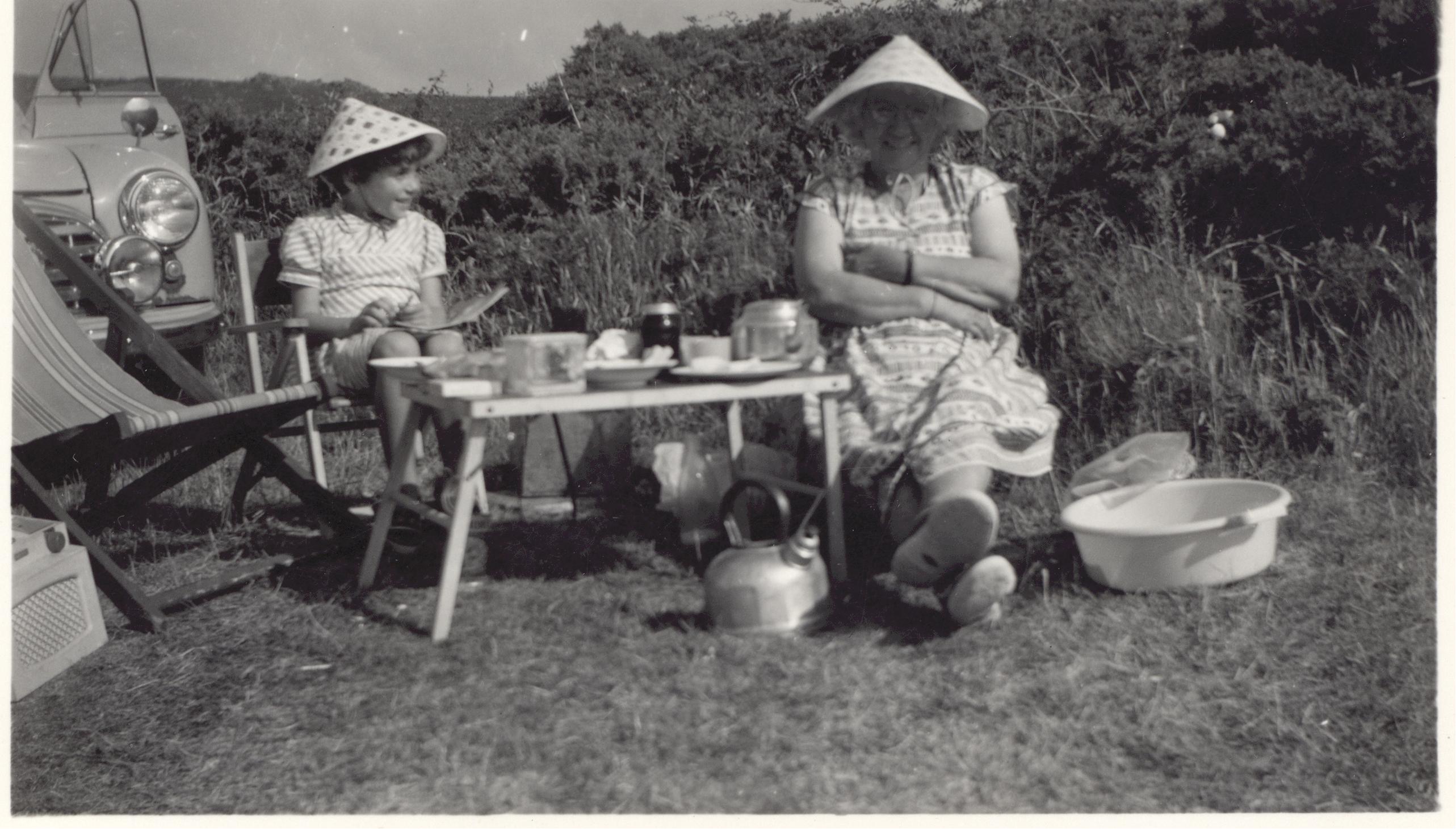 Beatrice Reed and girl in conical hats.