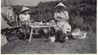 Beatrice Reed and girl in conical hats.