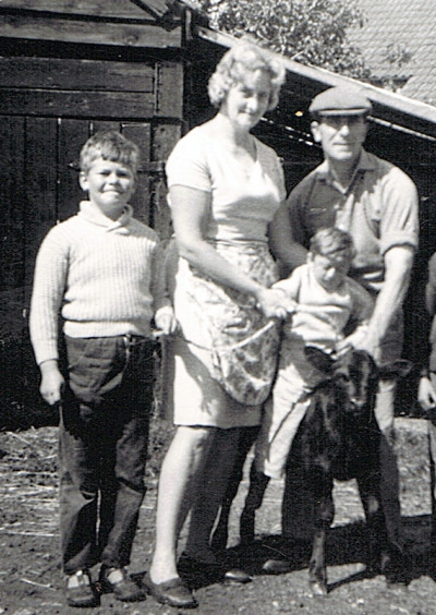 Members of the Male family with calf on farm
