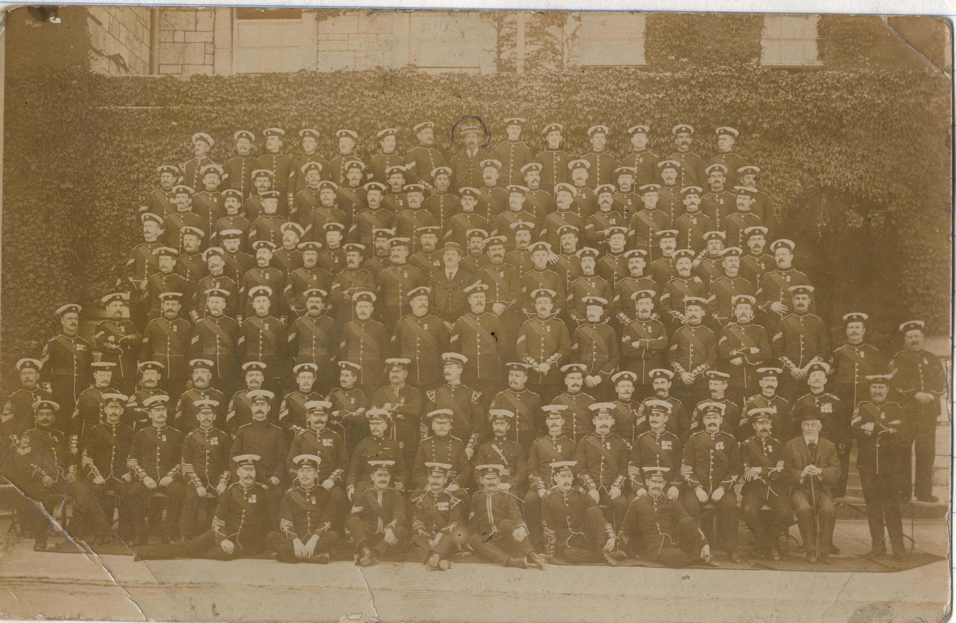 Large group of about 150 men in military uniform
