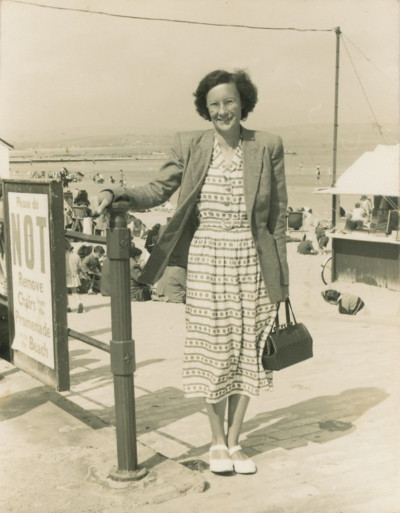 Young woman at entrance to beach
