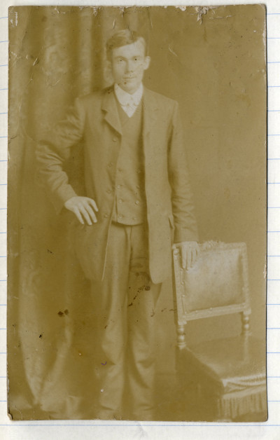 Man in suit next to chair