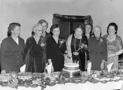 Group of women cutting cake in Methodist Church.