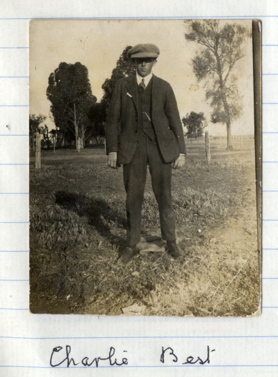 Charlie Best in suit and cap in field