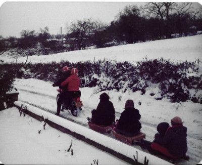 Children being towed on sledges.