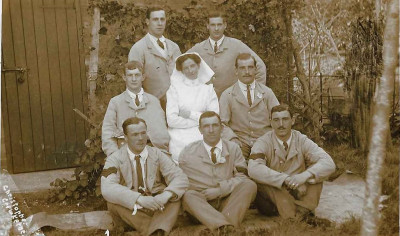 Nurse, with group of men
