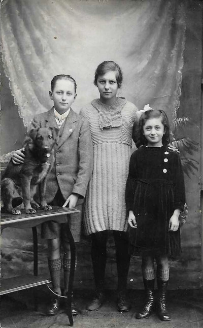Three children and dog in studio photo