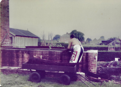 Ed Male loading withy bundles into boiler