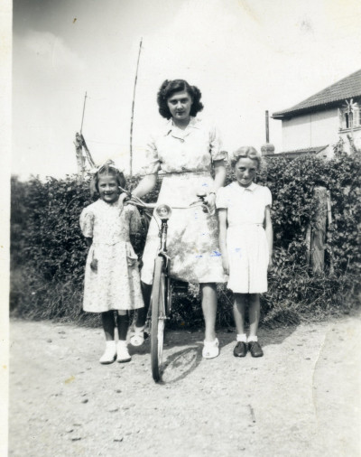 KC 723 Woman with two children and bike.