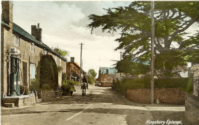 Colour Postcard with man on horse and  Taylors Garage looking South.