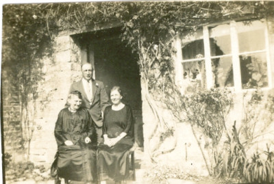 Man and two women in doorway.