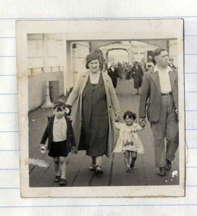 Family holding hands in train station