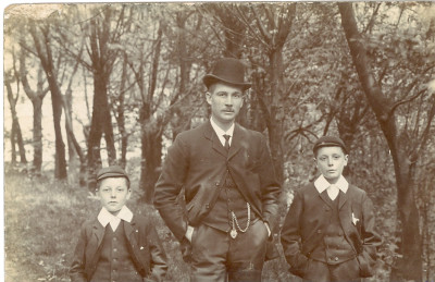 T. Linton  in bowler hat with sons in caps.