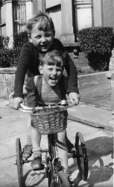 Children playing on tricycle