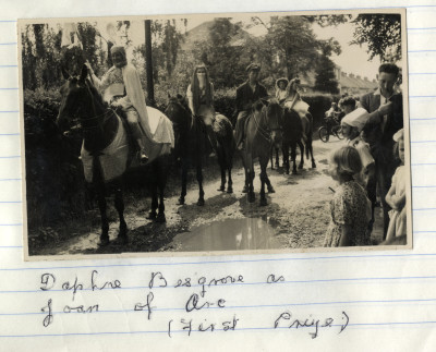 Group of adults & children in costumes on horses