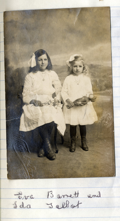 Two girls in studio photo wearing white dresses