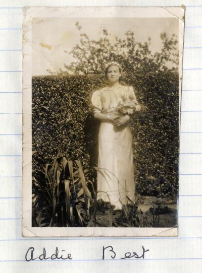 Addie Best in Bridesmaid Outfit - holding flowers