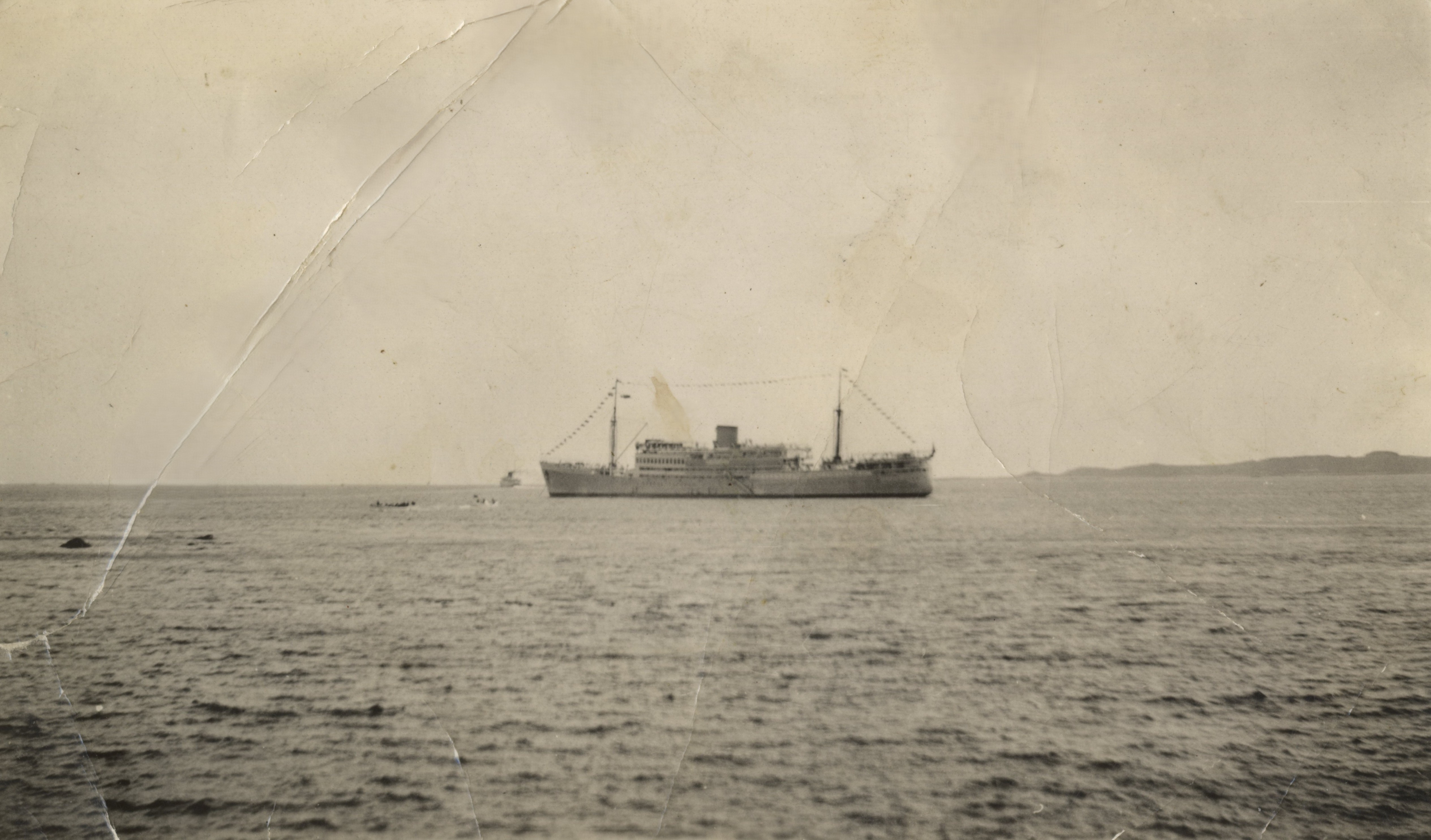 Ship with two rowing boats in water
