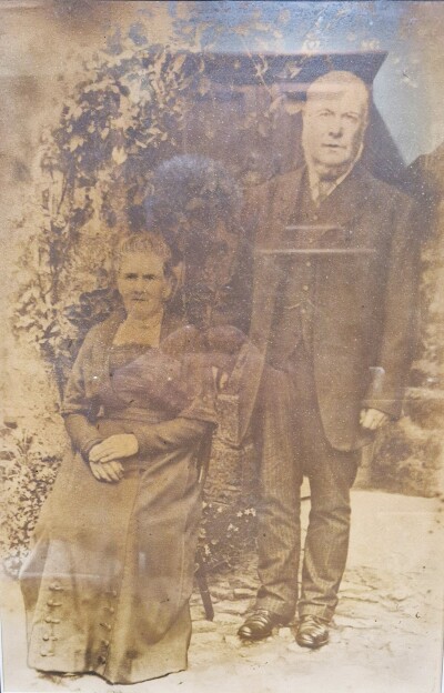 Victorian couple outside cottage