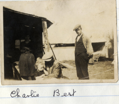 Men, woman & child in backyard shed