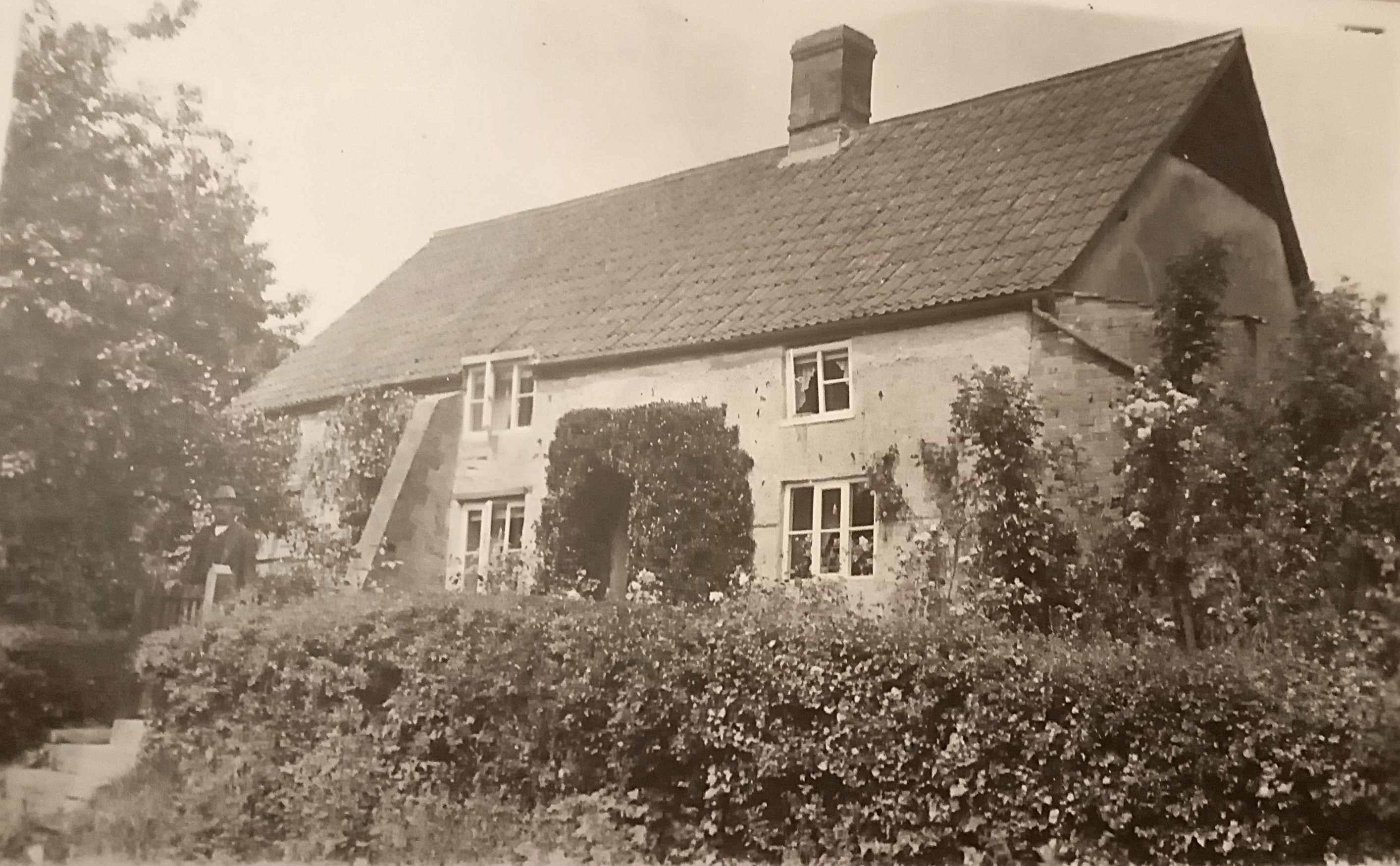 John Berriman outside cottage