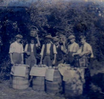 Porter family with barrels of apples and willow baskets