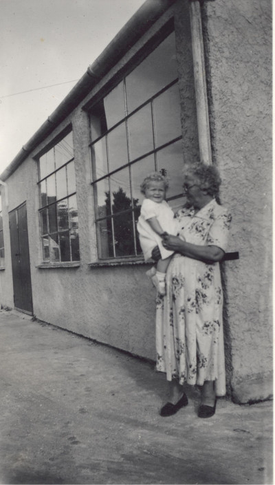 Grandmother and child outside Glove Factory