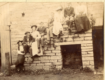 Group sat on external stone stairs at Thorney House
