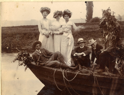 Small group of men and women on prow of coal barge