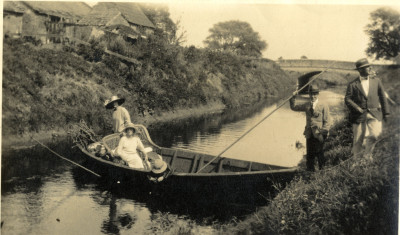 Two women and a child in a withy boat on the River Parrett