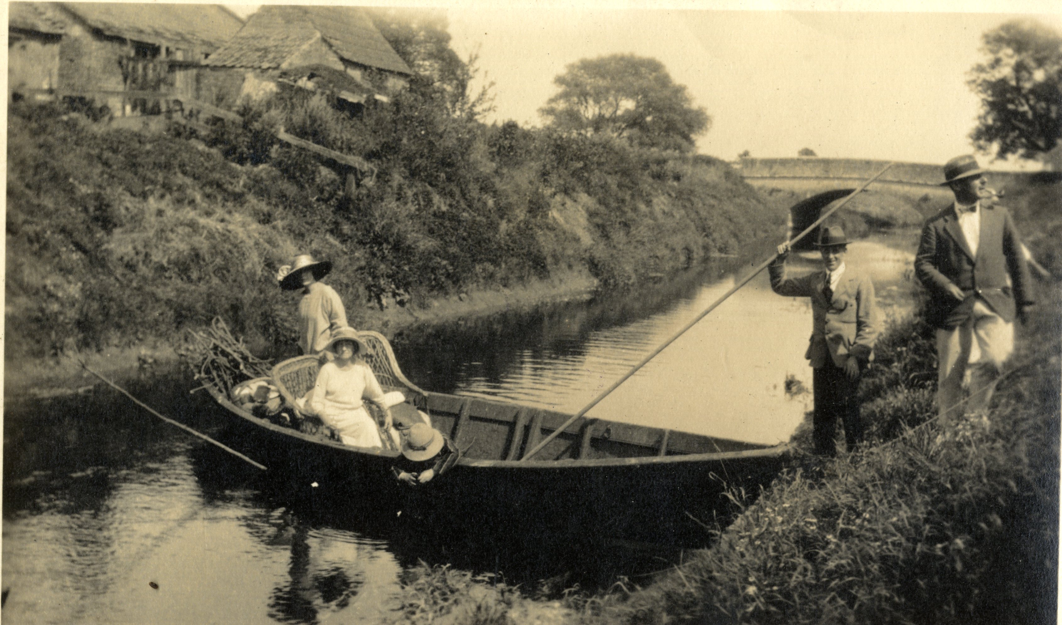 Two women and a child in a withy boat on the River Parrett