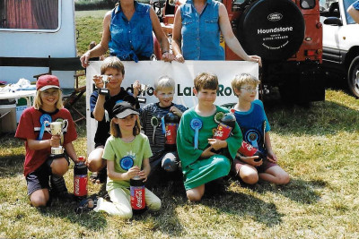 Photograph of children wearing rosettes and holding cups