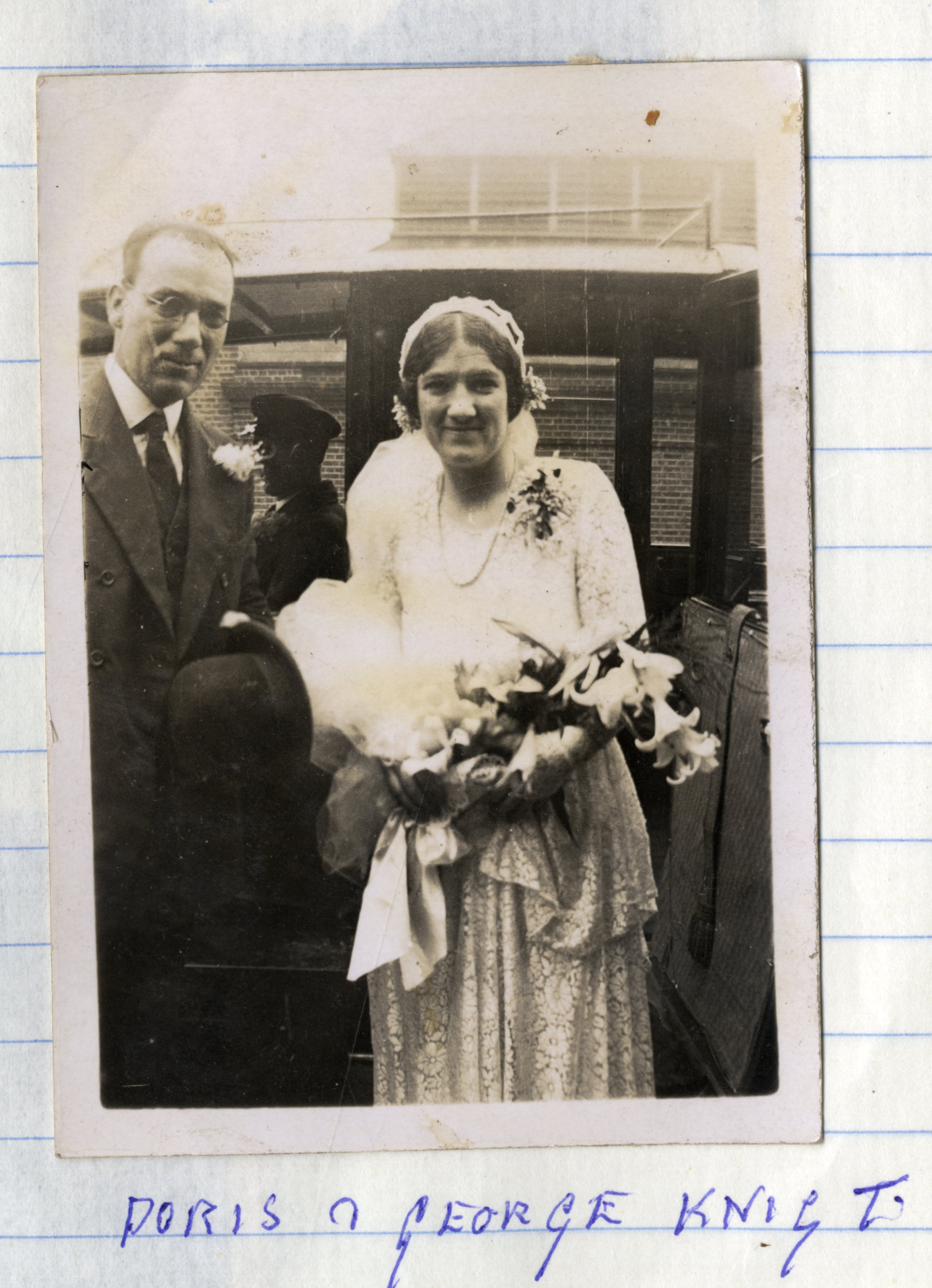 Newly weds standing by car